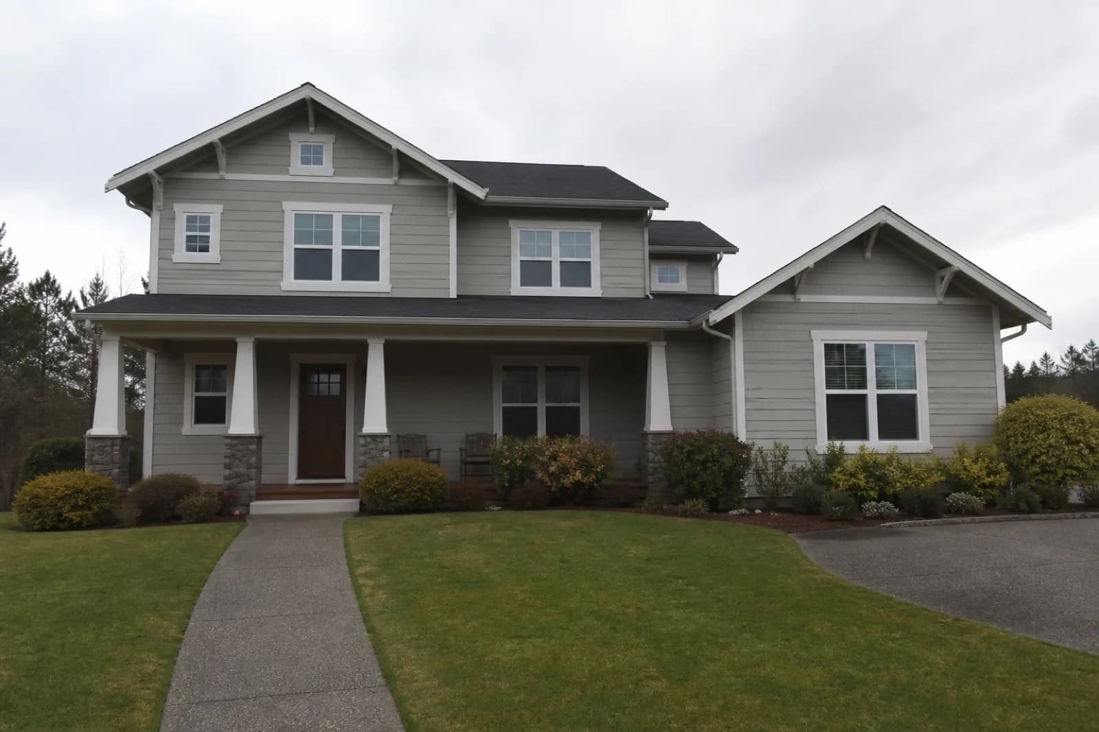 Original house exterior photo under a flat overcast sky