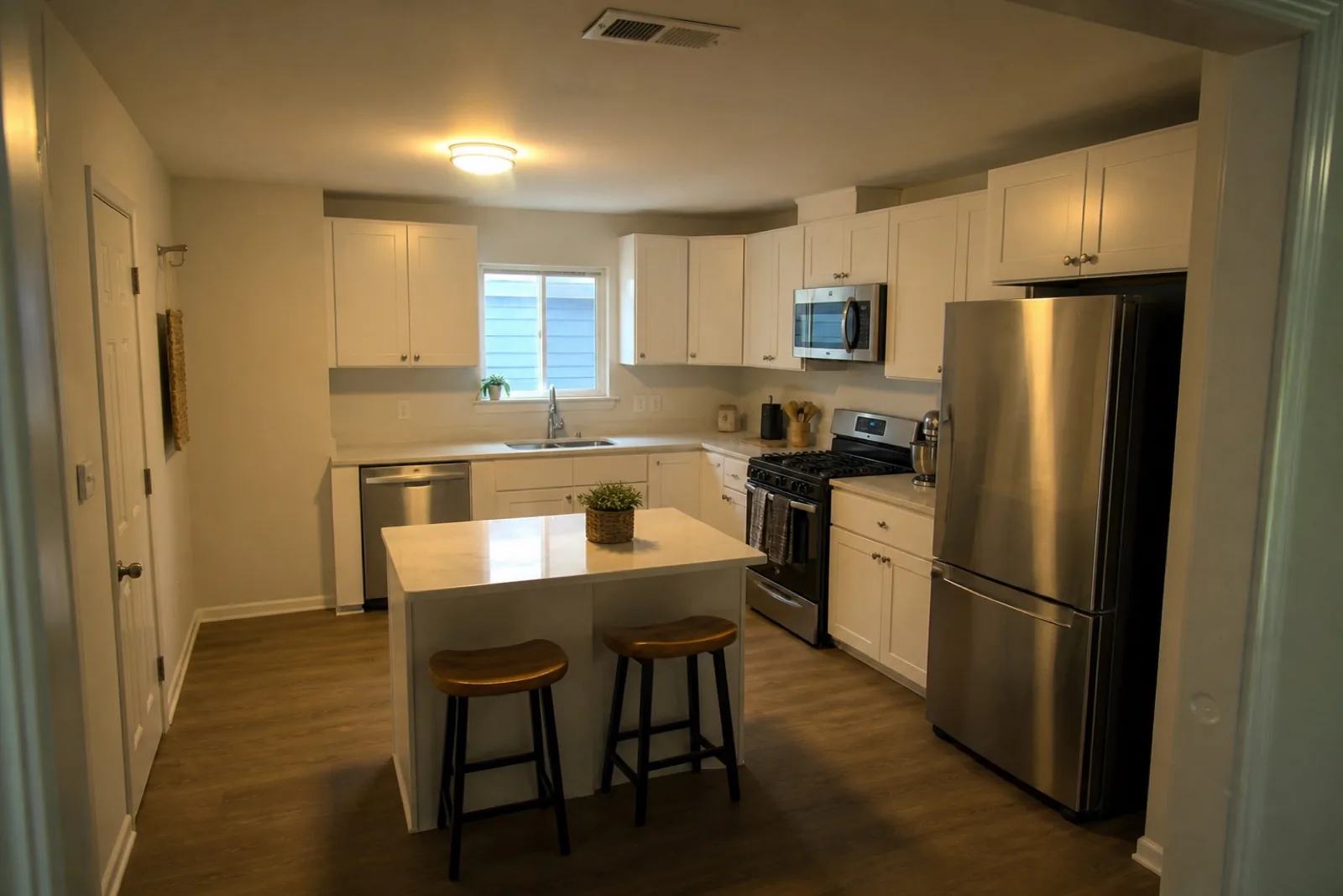 Original apartment kitchen photo with a warm color cast and dark foreground